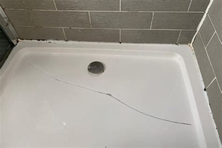 How do you fix a crack in a plastic shower pan