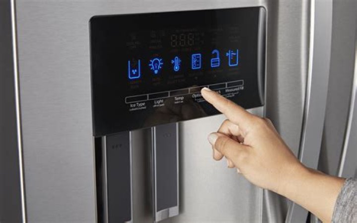 How do you reset the display panel on a Whirlpool refrigerator?