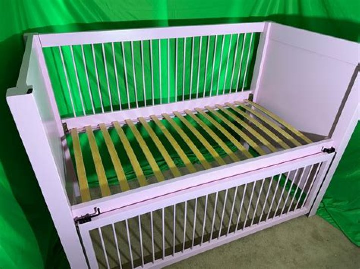 How to attach a front bar to a crib frame?