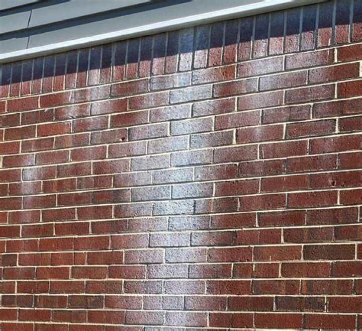 What causes white staining on new brickwork